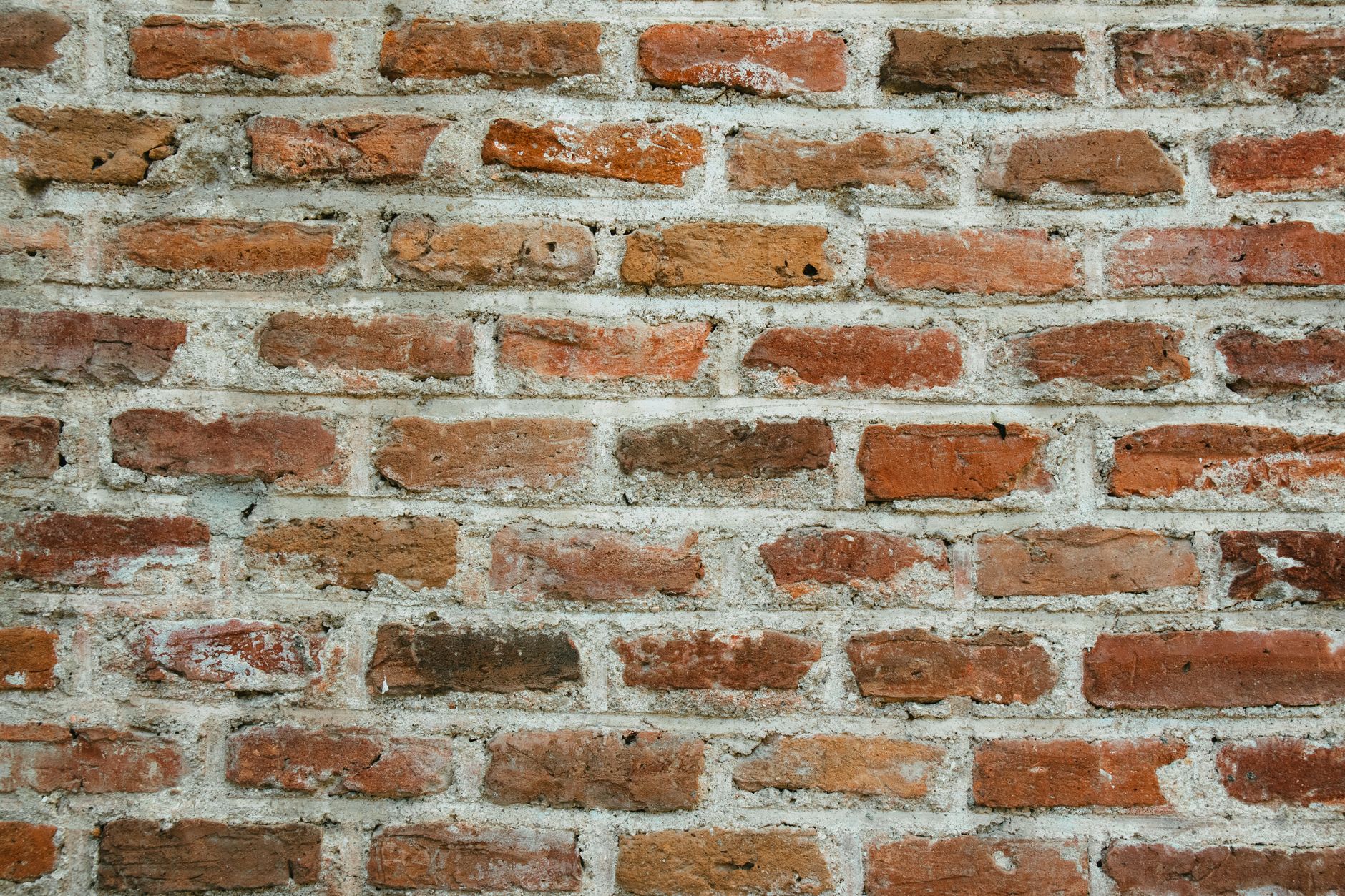 Freshly repointed red brick wall on a St. Louis two-family flat, with tooled mortar joints